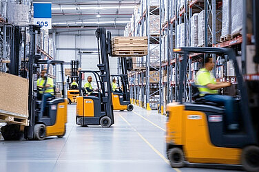 Several forklift trucks in a warehouse